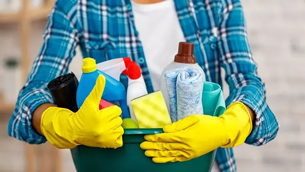 home services seo holding cleaning supplies with rubber gloves