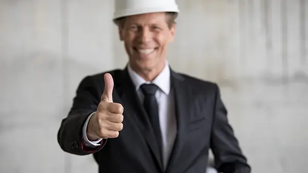 manufacturing engineer smiling and giving thumbs up