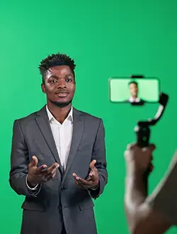content creation spokesperson man recording video content on green screen