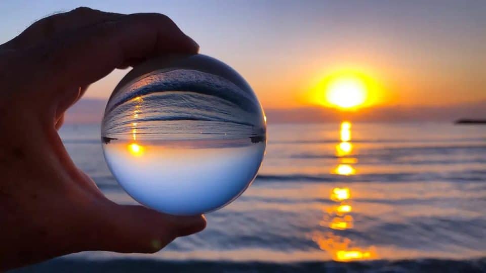 An image depicting the concept of looking at a sunrise through a crystal ball, symbolizing insights into the future of SEO and digital marketing strategies.